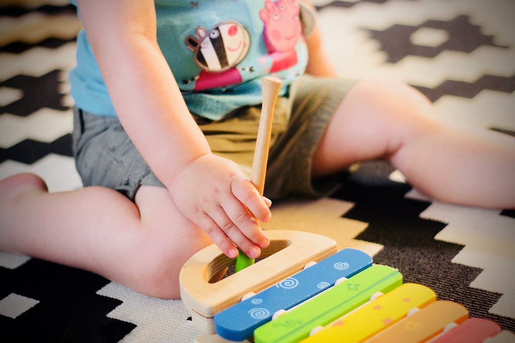 Toddler playing with musical toy