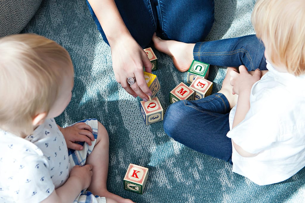 Teacher playing with 2 toddlers